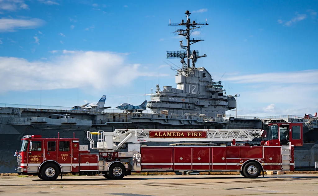 a fire truck in front of a ship
