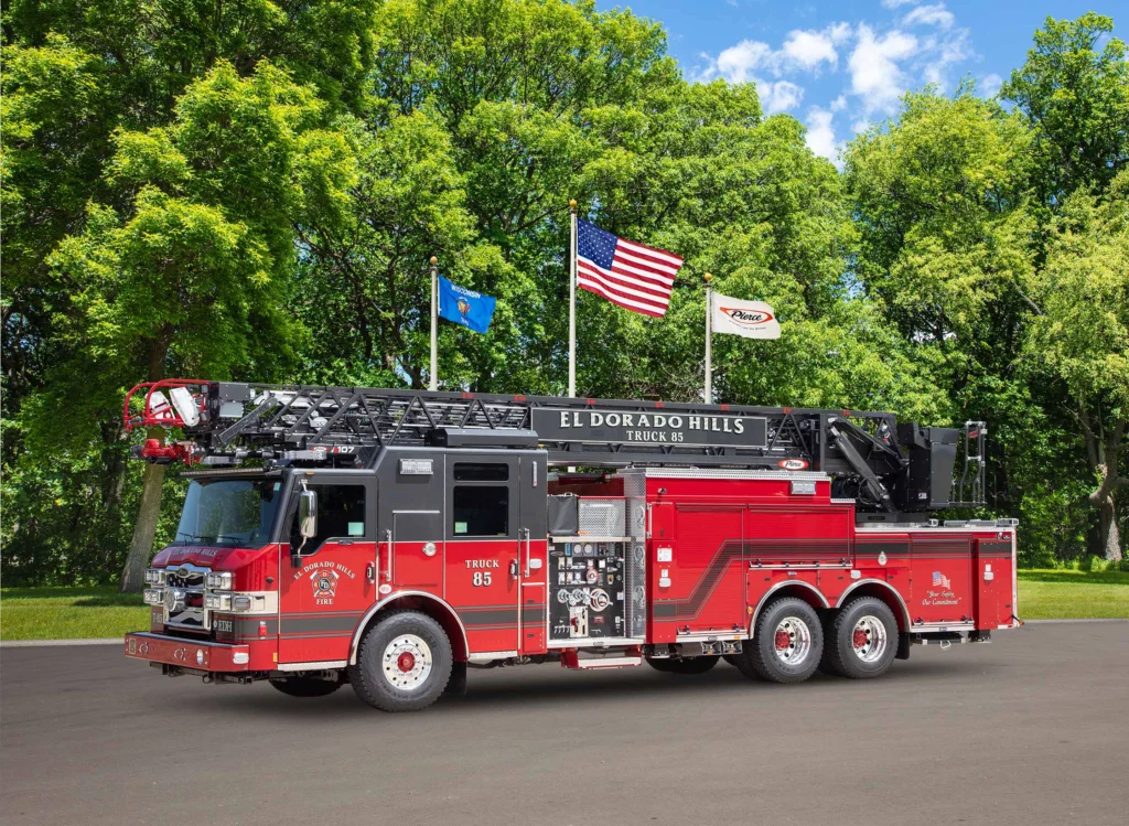 a fire truck in front of flag poles