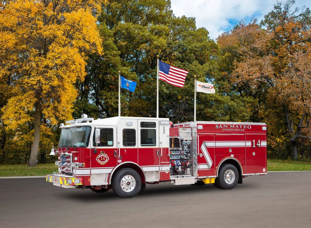 a fire truck in front of flag poles