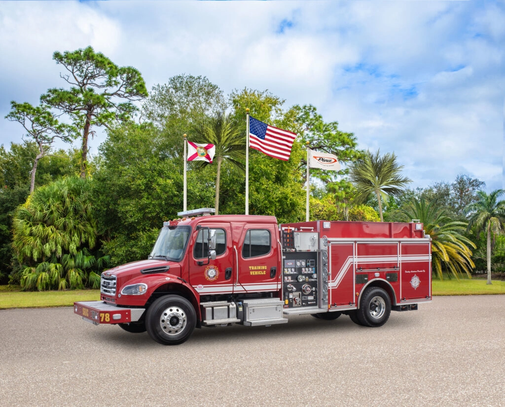 a fire truck in front of flag poles
