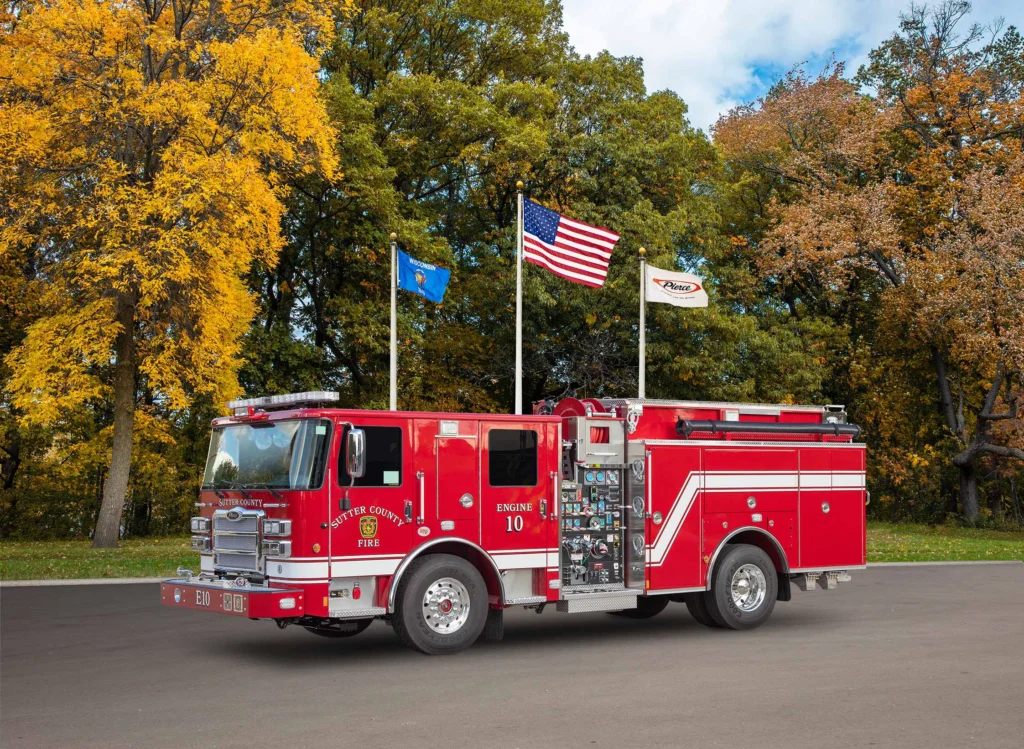 a fire truck in front of flag poles