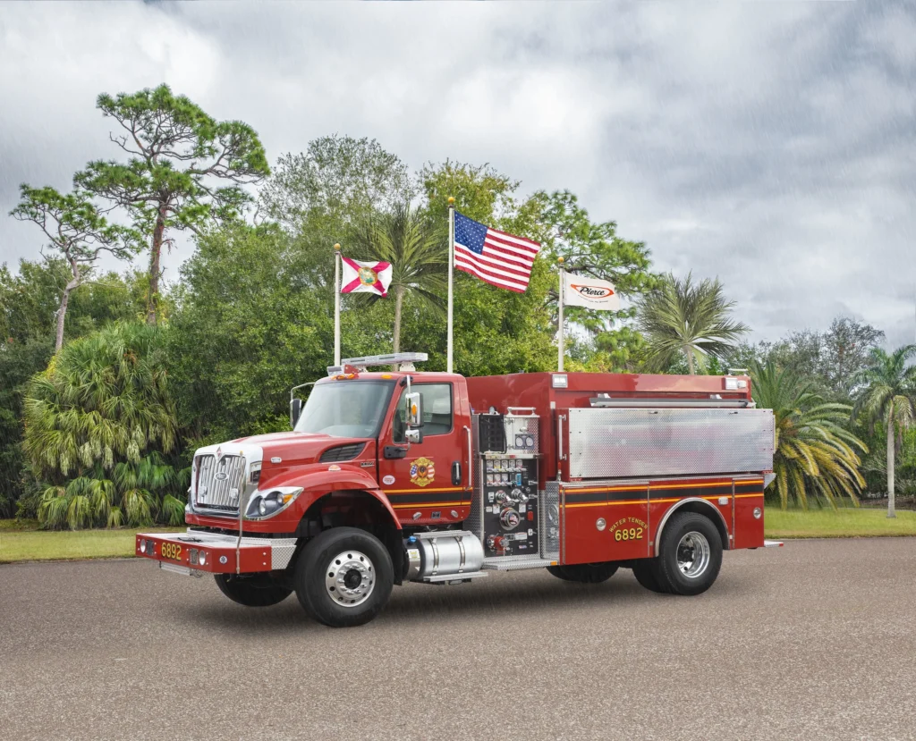 a fire truck in front of flag poles